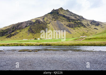 travel to Iceland - view of Skoga River and Skogar village at mountain slope near Skogafoss waterfall in Katla Geopark on Icelandic Atlantic South Coa Stock Photo