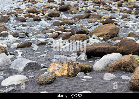 Travel To Iceland - Boulders At Surface Of Reynisfjara Beach In Iceland 