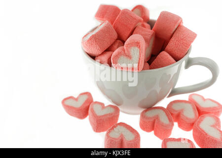 White and pink heart-shaped marshmallows are scattered from a cup 13730969  Stock Photo at Vecteezy