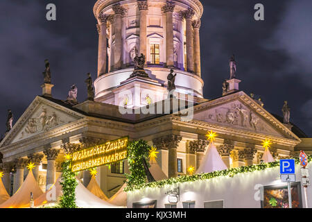 View over the Christmas Market 'Weihnachtszauber Gendarmenmarkt' with the illuminated New Church (Deutscher Dom) in the background, Berlin, Germany Stock Photo