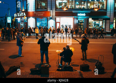 A band of men perform an impromptu winter rock concert in one of Kiev's main squares Stock Photo