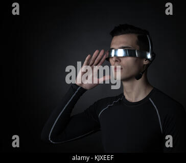 Man using futuristic VR goggles headset with microphone Stock Photo