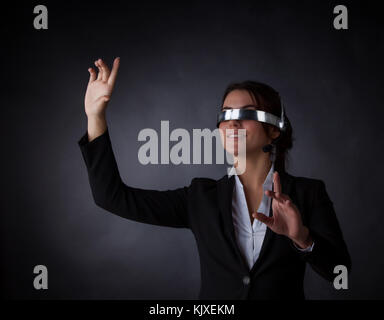Business woman using futuristic VR goggles headset with microphone Stock Photo