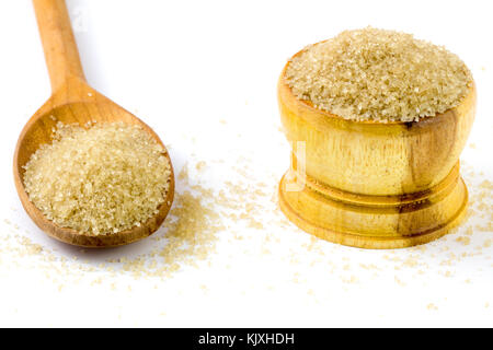 Full of wood Bowl and spoon with brown sugar on white background. Stock Photo