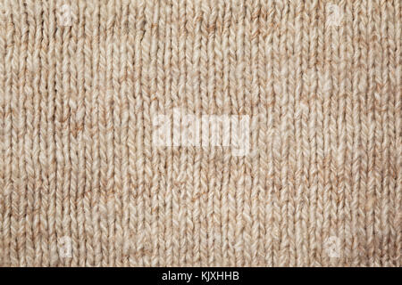 beige woolen knitted fabric close-up Stock Photo