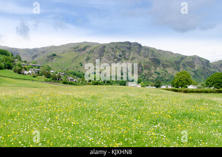 Looking up to The Old Man of Coniston shrouded by cloud Stock Photo