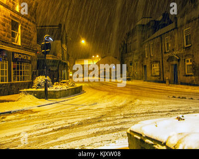 Otley in West Yorkshire showing the road junction of Bridge street, Clapgate and Courthouse street with snow falling on a cold February night. Stock Photo