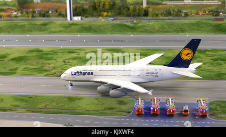 HAMBURG, GERMANY - MARCH 8th, 2014: An Lufthansa Airbus A380 taxiing to runway with fire department in hold at Flughafen Wunderland. Up to 40 different aircrafts, from Cessna to Airbus A 380, are taxing independently on Knufingen Airport at Miniatur Wunderland Museum to the gates Stock Photo