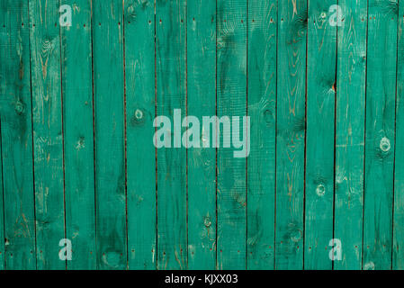 Dark lime vintage wooden boards. Backgrounds and textures fence painted. Front view. Attract beautiful vintage background. Stock Photo