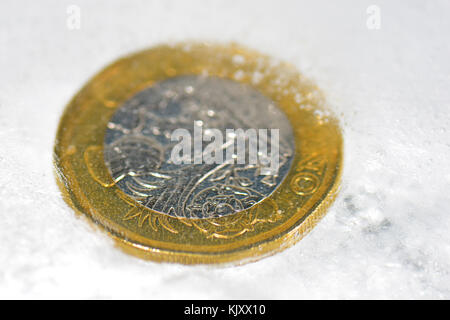 New One Pound coin frozen in ice Stock Photo