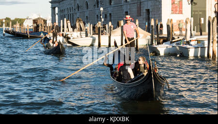 A Gondolier takes unknown tourists on a Gondola trip in Venice on September 12, 2017. Stock Photo