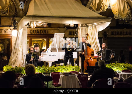 Unknown classical musicians entertain restaurant guests in Piazza San Marco in Venice on September 12, 2017. Stock Photo