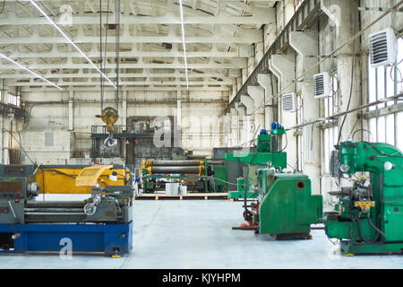 Nobody at industrial workshop with construction crane, drilling and welding machines Stock Photo