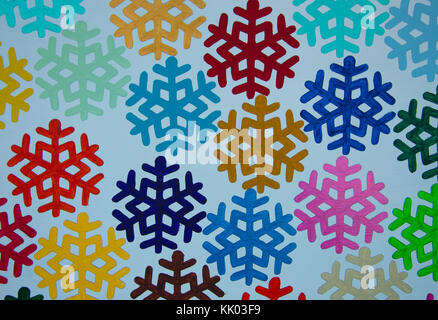 Colourful snowflakes on white wood background Stock Photo