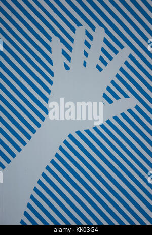 White hand print against blue and white stripes Stock Photo