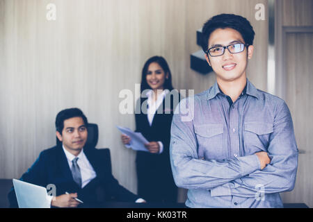 Asian businessmen and group using notebook for business partners discussing documents and ideas at meeting and business women smiling happy for workin Stock Photo