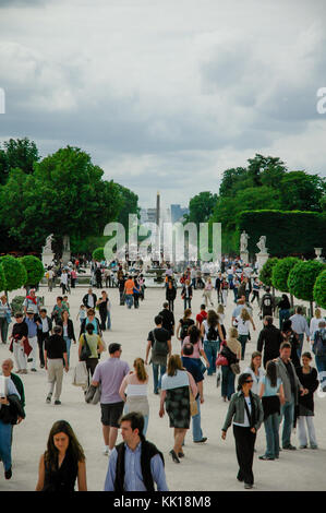 Tourists on the way to Louvre Museum admiring beautiful Tuileries Garden with the Grand Basin Rond in the background, Paris, France Stock Photo