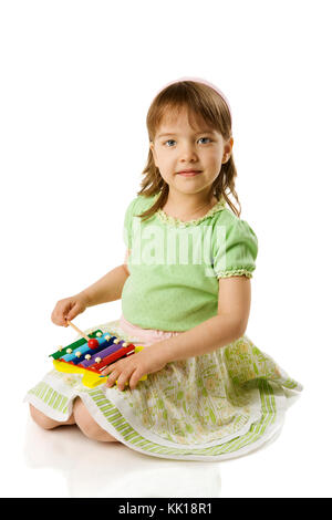 Girl playing on xylophone isolated on white Stock Photo