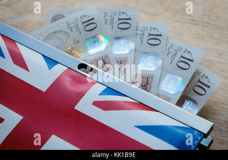 British money, five ten pound notes in purse with british flag design Stock Photo