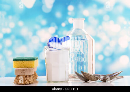 Eco-friendly natural cleaners baking soda, lemon and cloth on white and blue bubles background, Stock Photo