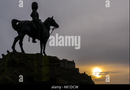 Silhouette of Royal Scots Greys Monument soldier on horseback by William Birnie Rhind, Princes St Gardens, Edinburgh, Scotland, UK, at sunset Stock Photo