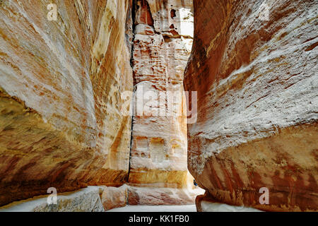 Pathway to the ancient city of Petra, Jordan. The pathway is a Siq - narrow gorge carved by water flow. Stock Photo