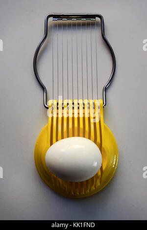 Hard-Boiled Egg in Yellow Egg Slicer Stock Photo