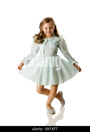 Cheerful girl spinning on floor isolated on white Stock Photo