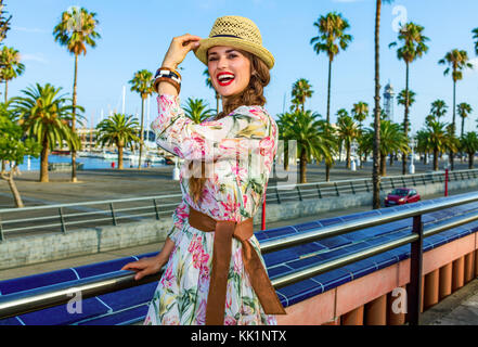 Summertime at colorful Barcelona. happy elegant woman in long dress and straw hat in Barcelona, Spain having fun time Stock Photo