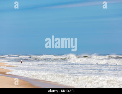 woman standing alone in the surf of an East Hampton ocean beach, east hamptonm, ny Stock Photo