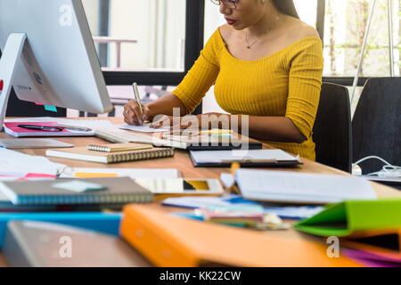 Closeup Asian Businesswoman with casual suit working and writing in modern Office, People business concept Stock Photo