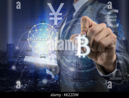 Double exposure of businessman using tablet and writing the bitcoins and block chain over the innovation technology virtual screen on cityscape backgr Stock Photo