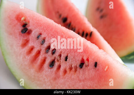 Three water melon slices, close up, on table Stock Photo