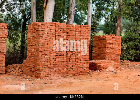 Piles of new red bricks outdoors Stock Photo