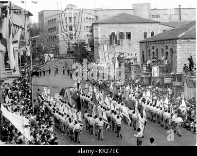 Zvi Oron (Oroshkess). Yom Ha'Atsma'ut (Israel Independence Day) parade in Jerusalem. School children dancing on Jaffa Road. 1960 (id.14457783) Stock Photo