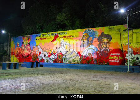 Huge street wall painting depicting Lord Ganesha, with people celebrating Ganapti festival, Pune Stock Photo