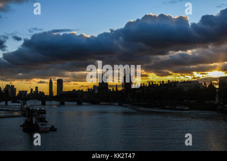 London UK. 28th November 2017. The Palace of Westminster is silhouetted as clouds move  in creating a dramatic autumn sunset Stock Photo