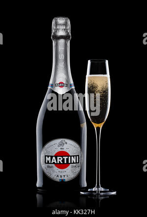 LONDON, UK - November 24, 2017: Bottle and glass of sparkling wine Martini Asti on black background. Produced in Italy Stock Photo