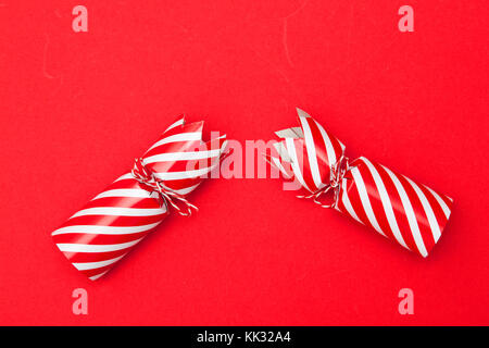 Christmas crackers on a red background Stock Photo