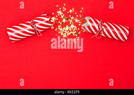 Christmas crackers on a red background Stock Photo