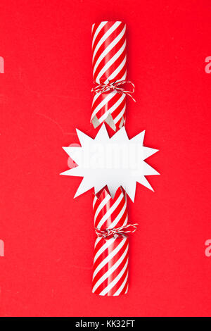 Popped Christmas crackers on a red background Stock Photo