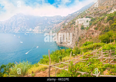view of Positano, sea and surrounding mountains from small vineyard on summer day, Amalfi coast, Praiano, Italy
