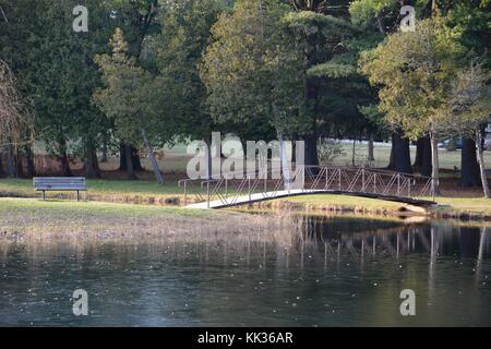 Victorian arched bridges, islands and fountains in Crandall Park in Glens Falls, Upstate New York, United States of America in the Autumn Stock Photo