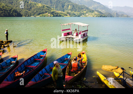 a couple of tourist preparing for a boat ride, Phewa Lake, Mid-Western region, Pokhara, Nepal Stock Photo