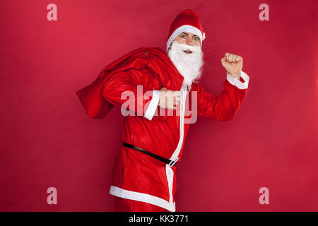 Santa runs with an empty bag Stock Photo