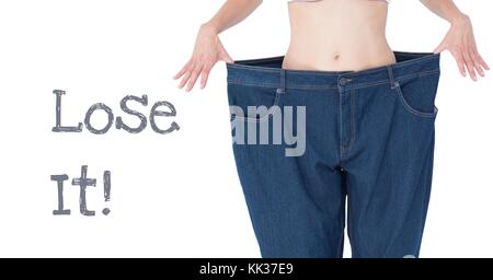 Digital composite of Lose it text and fit woman's waist in oversized trousers Stock Photo