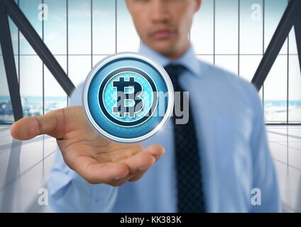 Digital composite of Bitcoin icon and Businessman with hand palm open in city office Stock Photo