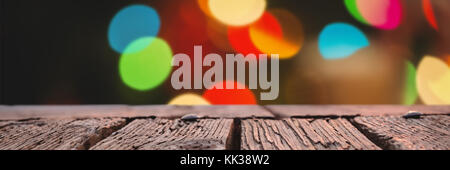 Rusty wooden plank against defocused of christmas tree lights and fireplace Stock Photo