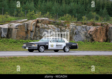 PAIMIO, FINLAND - AUGUST 26, 2016: Cadillac Police car of Arizona Route 66 Sheriff moves along freeway in South of Finland. Stock Photo
