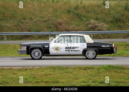 PAIMIO, FINLAND - AUGUST 26, 2016: Classic Cadillac Police car of Arizona Route 66 Sheriff along freeway in South of Finland. Stock Photo